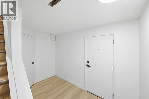 Bottom of stairs in basement - 2404 51 Street Ne, Calgary, AB - Indoor Photo Showing Other Room