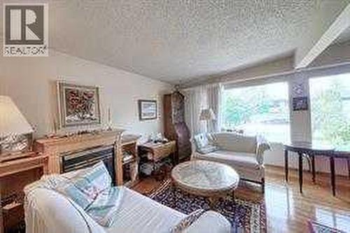 10212 8 Street Sw, Calgary, AB - Indoor Photo Showing Living Room With Fireplace