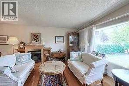 10212 8 Street Sw, Calgary, AB - Indoor Photo Showing Living Room With Fireplace