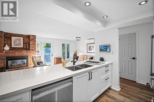 2058 Brant Street Unit# 3, Burlington, ON - Indoor Photo Showing Kitchen With Fireplace With Double Sink
