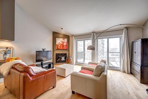 Living room - 402-651 Rue Jacques-Lavigne, Sainte-Thérèse, QC - Indoor Photo Showing Living Room With Fireplace