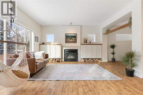 196 Jumping Pound Terrace, Cochrane, AB - Indoor Photo Showing Living Room With Fireplace