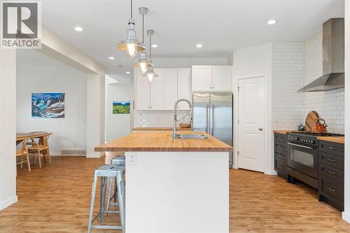 196 Jumping Pound Terrace, Cochrane, AB - Indoor Photo Showing Kitchen With Double Sink With Upgraded Kitchen