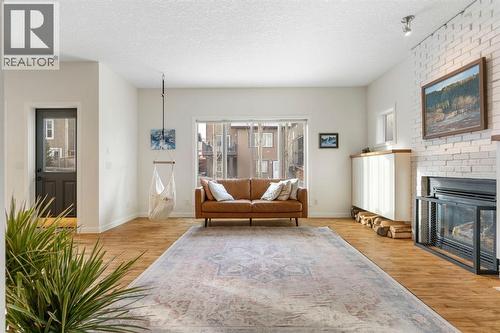 196 Jumping Pound Terrace, Cochrane, AB - Indoor Photo Showing Living Room With Fireplace
