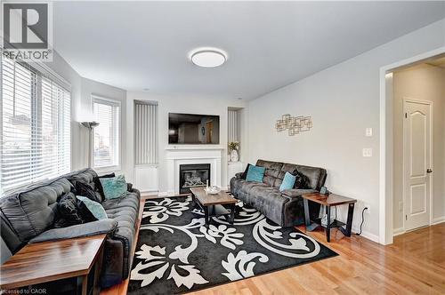 Living room with light wood-style floors and a glass covered fireplace - 32 Weir Street, Cambridge, ON - Indoor Photo Showing Living Room With Fireplace