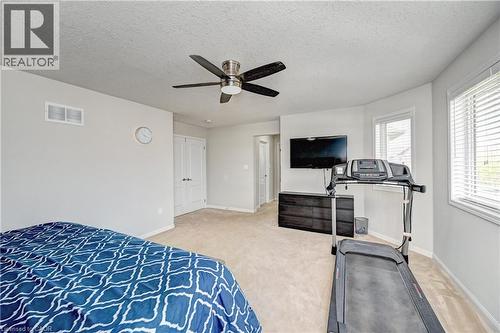Bedroom with a textured ceiling, light carpet, and ceiling fan - 32 Weir Street, Cambridge, ON - Indoor Photo Showing Bedroom