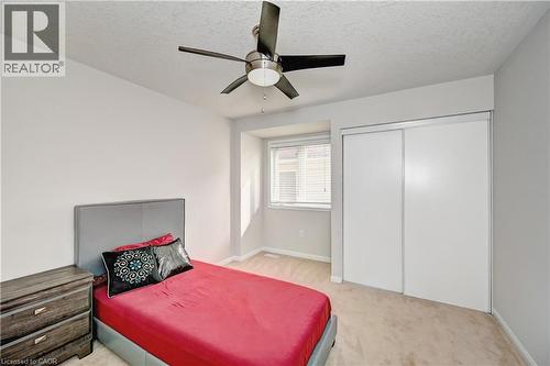 Bedroom with light colored carpet, a textured ceiling, and ceiling fan - 32 Weir Street, Cambridge, ON - Indoor Photo Showing Bedroom