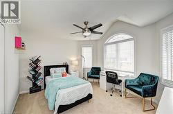 Bedroom with light colored carpet and ceiling fan - 