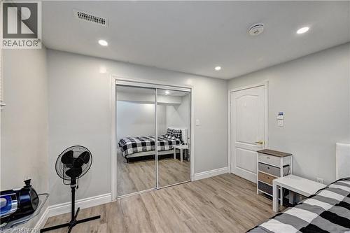 Bedroom featuring light wood-style floors, recessed lighting, and a closet - 32 Weir Street, Cambridge, ON - Indoor