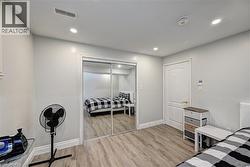Bedroom featuring light wood-style floors, recessed lighting, and a closet - 