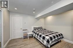 Bedroom with light wood-type flooring and recessed lighting - 