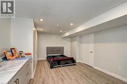 Bedroom featuring light wood finished floors and recessed lighting - 