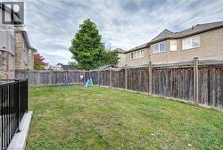 Fenced backyard featuring a playground - 