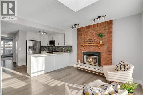 17 Mckernan Road Se, Calgary, AB - Indoor With Fireplace