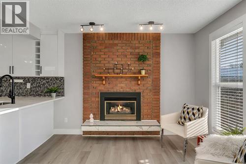 17 Mckernan Road Se, Calgary, AB - Indoor Photo Showing Living Room With Fireplace