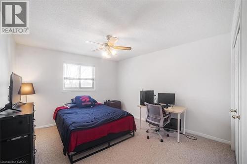 Bedroom with a desk, light colored carpet, a ceiling fan, and a textured ceiling - 25 Meadowvale Drive Unit# 3, Fonthill, ON - Indoor Photo Showing Bedroom
