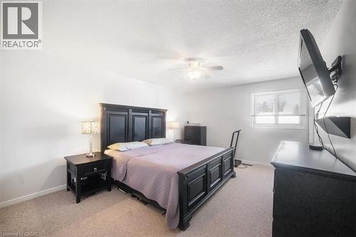 Bedroom featuring light carpet, ceiling fan, and a textured ceiling - 25 Meadowvale Drive Unit# 3, Fonthill, ON - Indoor Photo Showing Bedroom