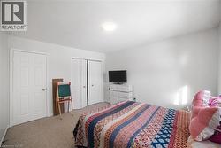 Bedroom featuring carpet flooring, a textured ceiling, and a closet - 