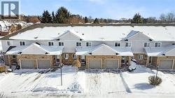 View of front of home featuring brick siding and a garage - 