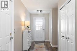 Doorway to outside featuring wood finished floors and a textured ceiling - 