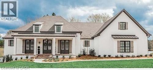 View of front facade with covered porch, a front lawn, a standing seam roof, stucco siding, and a metal roof - 16 Abingdon Road Unit# 7, Caistor Centre, ON - Outdoor With Facade