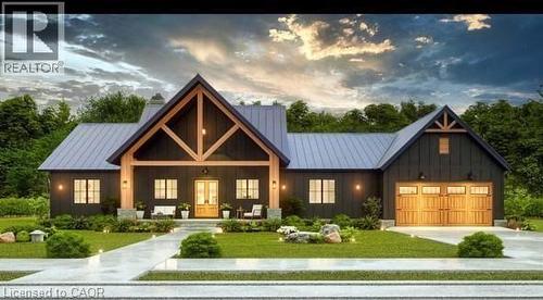 View of front facade featuring board and batten siding, a metal roof, a standing seam roof, a lawn, and concrete driveway - 16 Abingdon Road Unit# 7, Caistor Centre, ON - Outdoor With Facade