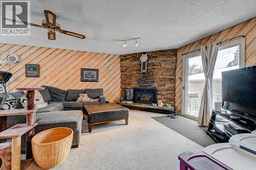 1455 Russell Road Ne, Calgary, AB - Indoor Photo Showing Living Room With Fireplace