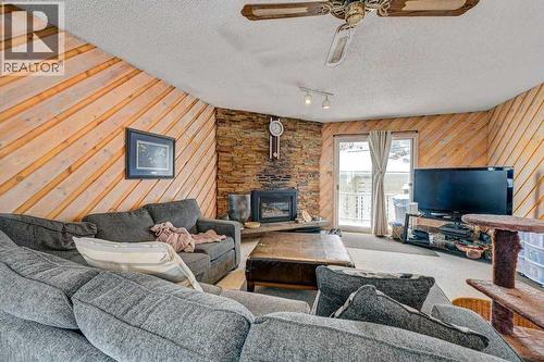 1455 Russell Road Ne, Calgary, AB - Indoor Photo Showing Living Room With Fireplace
