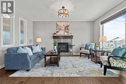 Bright and sunny living room - 69 Ravenskirk Close Se, Airdrie, AB - Indoor Photo Showing Living Room With Fireplace