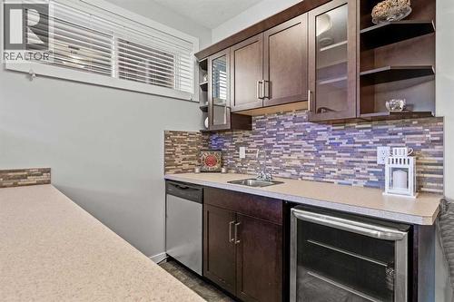 Dishwasher and bar fridge - 69 Ravenskirk Close Se, Airdrie, AB - Indoor Photo Showing Kitchen