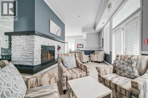 1113, 1113 Lake Fraser Green Se, Calgary, AB - Indoor Photo Showing Living Room With Fireplace