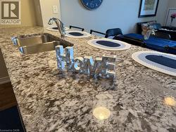 Detailed view of light stone countertops and a sink - 