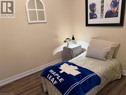 Bedroom with baseboards and dark wood-style floors - 