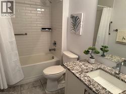 Bathroom featuring vanity, shower / tub combo with curtain, and light tile patterned flooring - 