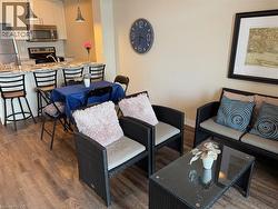 Living room with dark wood-style floors and baseboards - 
