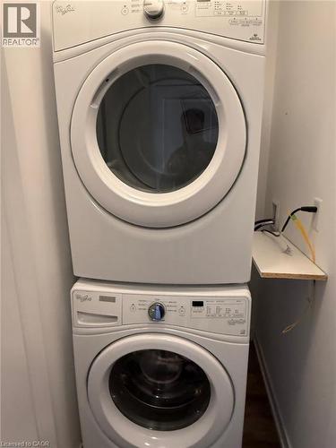 Laundry area featuring estacked washer and dryer - 35 Southshore Crescent Unit# 303, Stoney Creek, ON - Indoor Photo Showing Laundry Room
