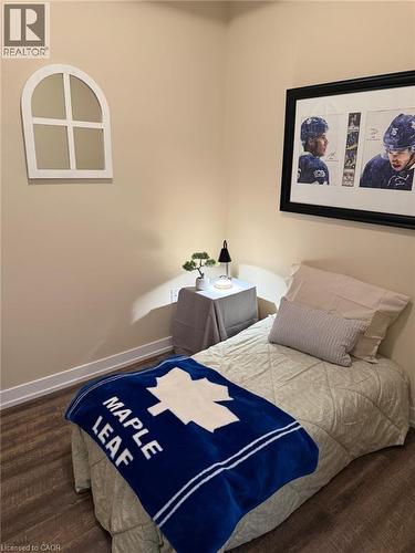 Bedroom with baseboards and dark wood finished floors - 35 Southshore Crescent Unit# 303, Stoney Creek, ON - Indoor Photo Showing Bedroom