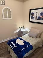 Bedroom with baseboards and dark wood finished floors - 