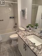 Bathroom featuring vanity and shower / bath combo with shower curtain - 