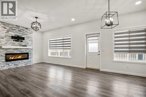 223 Savanna Way Ne, Calgary, AB - Indoor Photo Showing Other Room With Fireplace