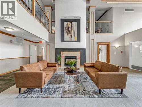 208, 1182 Southview Drive Se, Medicine Hat, AB - Indoor Photo Showing Living Room With Fireplace
