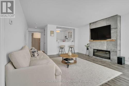 605 - 140 Dunlop Street E, Barrie, ON - Indoor Photo Showing Living Room With Fireplace