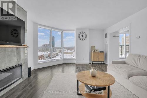 605 - 140 Dunlop Street E, Barrie, ON - Indoor Photo Showing Living Room With Fireplace
