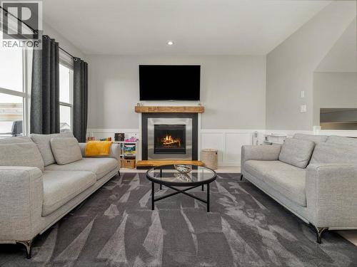 102 Blackwolf Bay N, Lethbridge, AB - Indoor Photo Showing Living Room With Fireplace