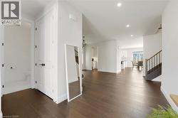 Corridor featuring stairway, dark wood-type flooring, and recessed lighting - 