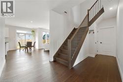 Stairway featuring recessed lighting and wood finished floors - 