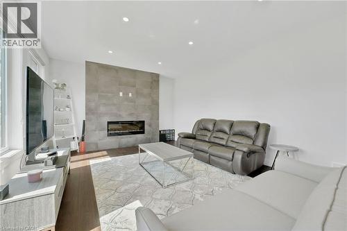 Living room with light wood-style flooring, a fireplace, and recessed lighting - 7266 Silver Creek Circle, London, ON - Indoor Photo Showing Living Room With Fireplace