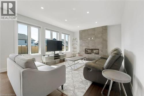 Living area with a fireplace, recessed lighting, and wood finished floors - 7266 Silver Creek Circle, London, ON - Indoor Photo Showing Living Room With Fireplace