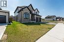 French country home featuring brick siding, a front yard, a garage, and concrete driveway - 7266 Silver Creek Circle, London, ON  - Outdoor 