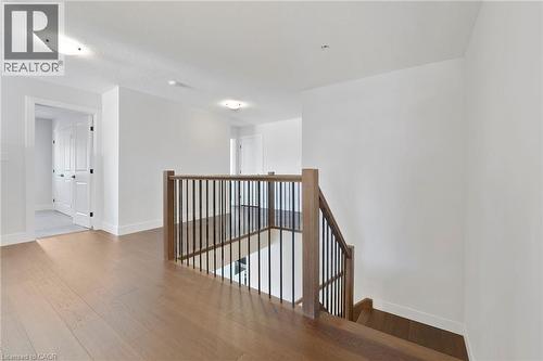 Corridor with wood finished floors and an upstairs landing - 7266 Silver Creek Circle, London, ON - Indoor Photo Showing Other Room